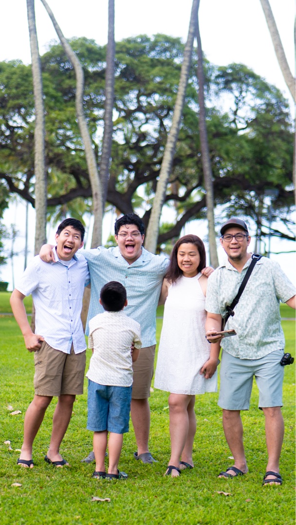 Family laughing together at Fort DeRussy Park, Waikiki