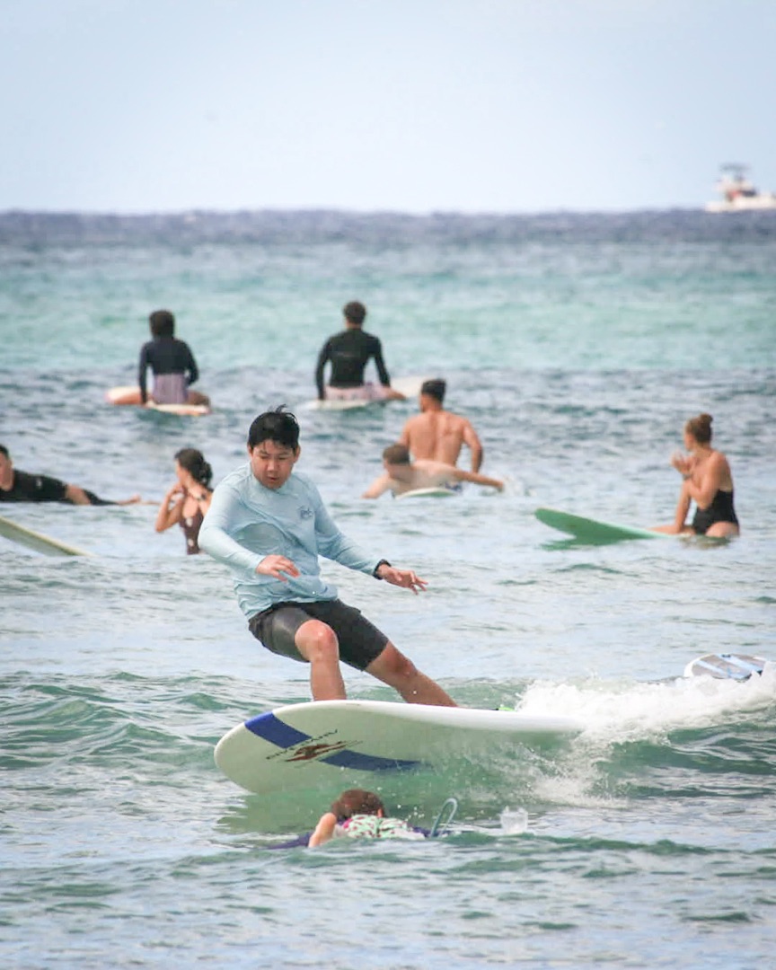Catching waves surfing at Waikiki Beach, Oahu